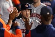 Alex Bregman celebrates with teammates in the dugout after scoring a run during last night's Houston Astros v Chicago White Sox game in Chicago, Illinois.